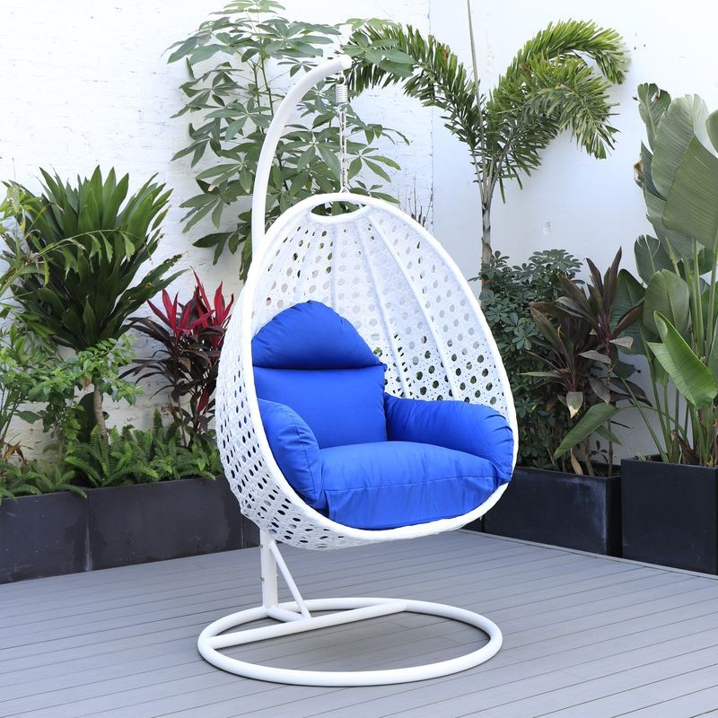 LeisureMod White Wicker Hanging Egg Swing Chair Blue on Patio.