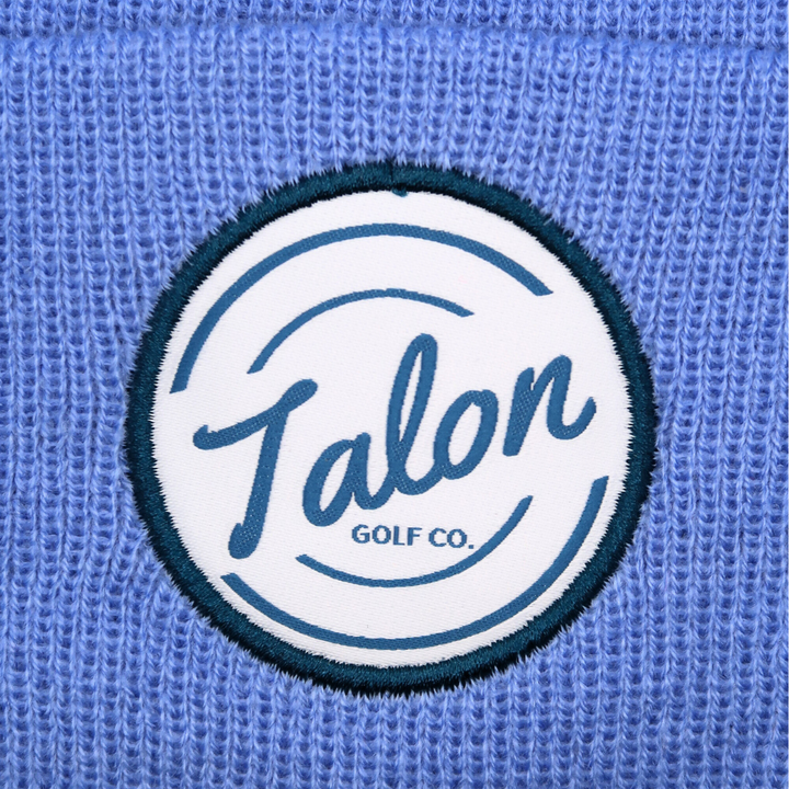 Blue Knit Beanie with White Talon Circle Logo Closeup.