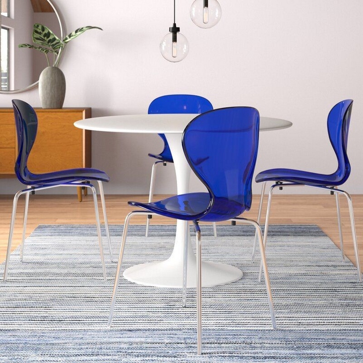 LeisureMod 5-Piece Dining Set Round White MDF Dining Table and 4 Plastic Dining Chairs with Chrome Legs Transparent Blue in Room.