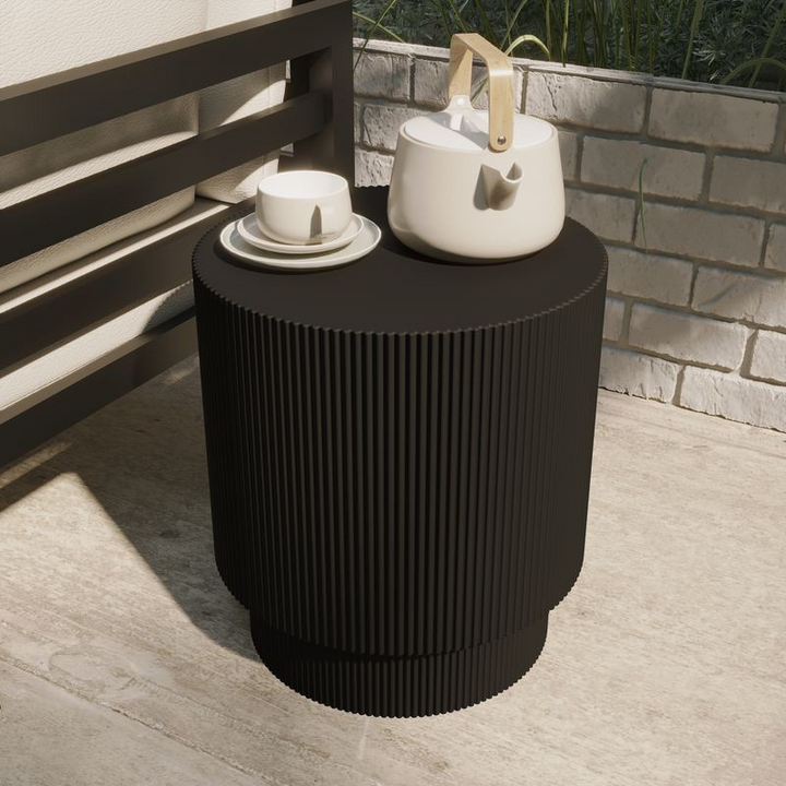 LeisureMod Eden Collection Fiberglass Outdoor Side Table in Black on Patio.