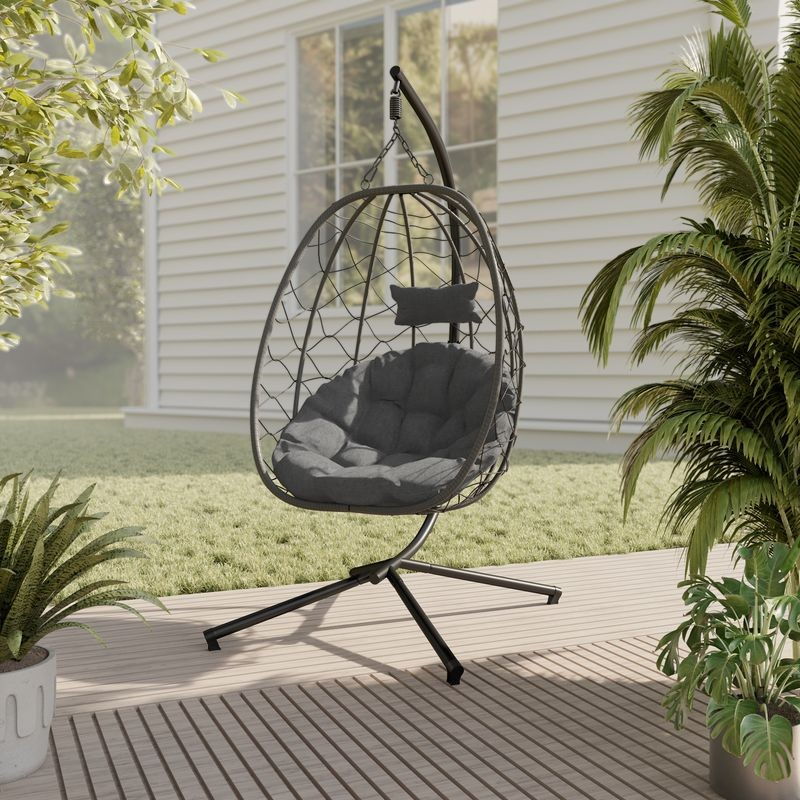 Leisuremod Summit Series Outdoor Egg Swing Chair in Black with Charcoal Cushions on Patio.