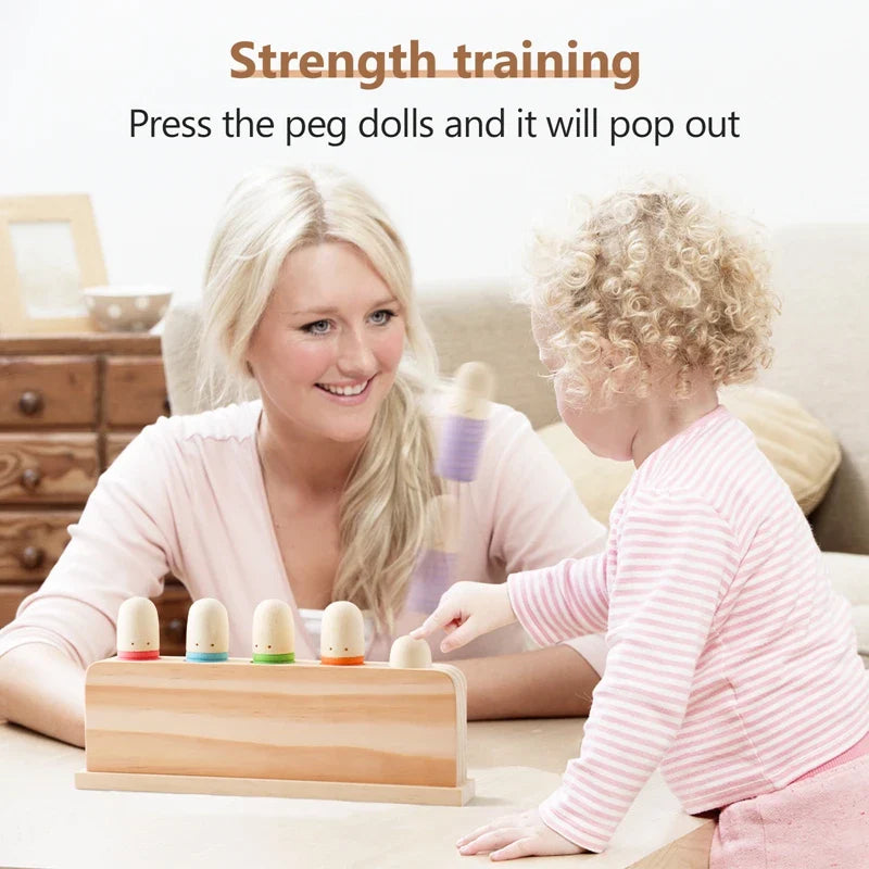 Woman and child playing with a wooden peg doll strength training toy.