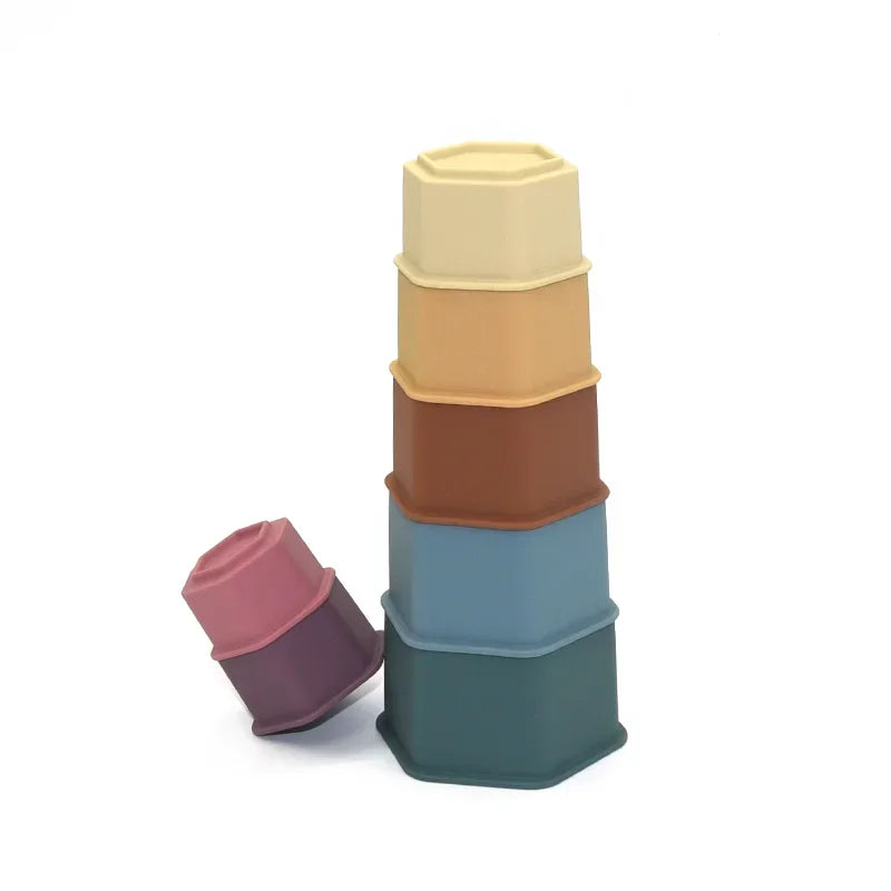 Stack of colorful hexagonal containers on a white background.