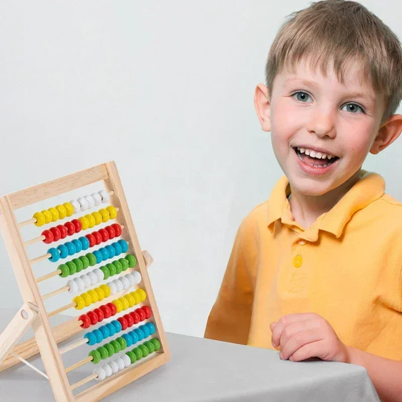 Child holding a colorful abacus against a plain background.