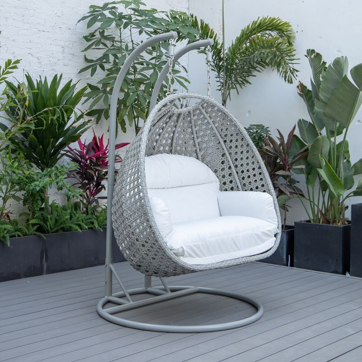 LeisureMod Mendoza Light Grey Wicker Hanging 2 Person Egg Swing Chair White on Patio.