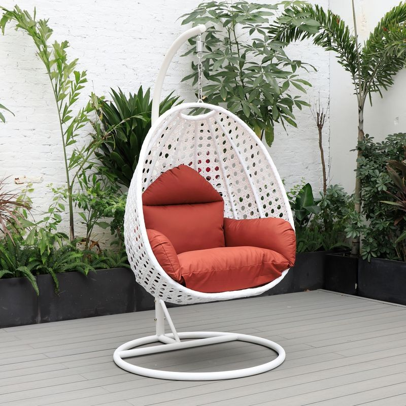 LeisureMod White Wicker Hanging Egg Swing Chair Cherry on Patio.