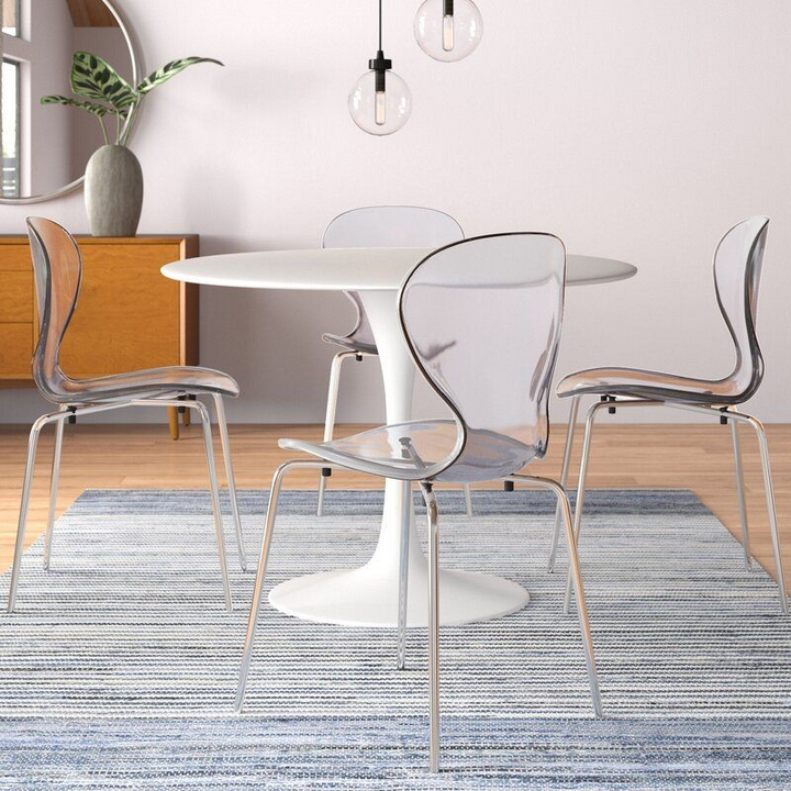 LeisureMod 5-Piece Dining Set Round White MDF Dining Table and 4 Plastic Dining Chairs with Chrome Legs Clear in Room.