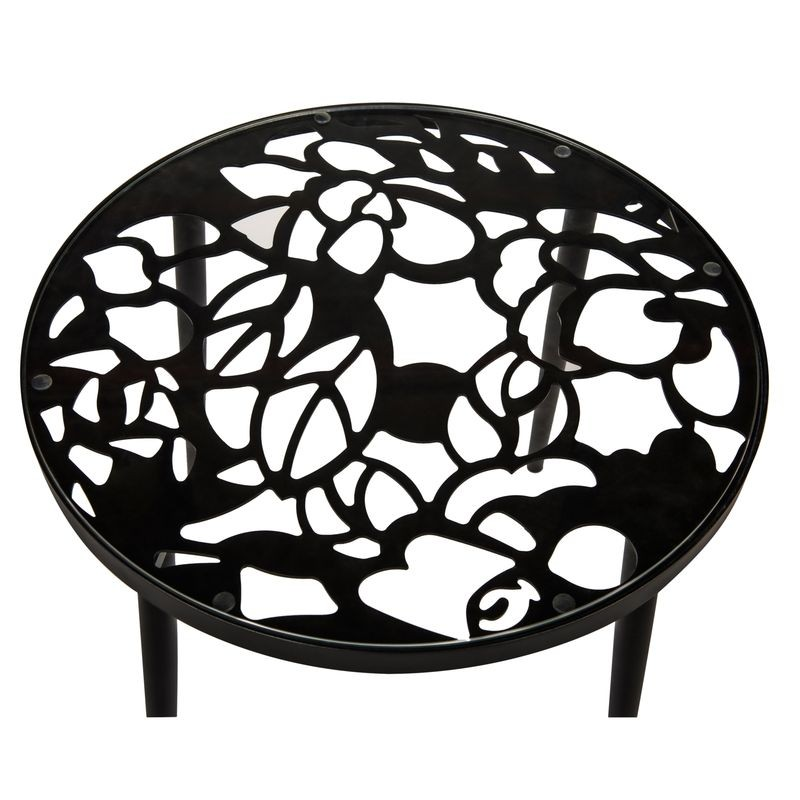 Black metal fire pit with decorative cut-out design on a white background.