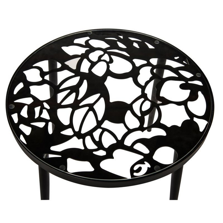 Black metal fire pit with decorative cut-out design on a white background.