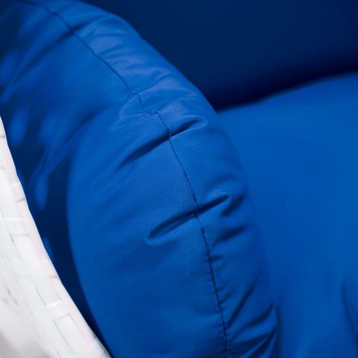 LeisureMod White Wicker Hanging Egg Swing Chair Blue Cushion Closeup.