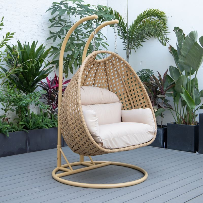 LeisureMod Mendoza Light Brown Wicker Hanging 2 Person Egg Swing Chair Beige on Patio.