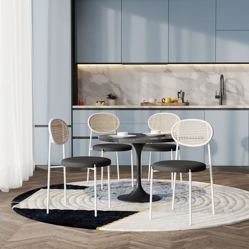 LeisureMod 5-Piece Dining Set with 36" Round Dining Table Black Sintered Stone Top and Black Pedestal with 4 Velvet Dining Chairs in White Steel Legs in Black in Room.