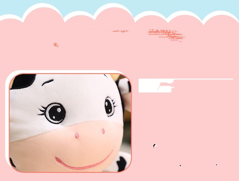 Plush cow toy with a pink scalloped border.