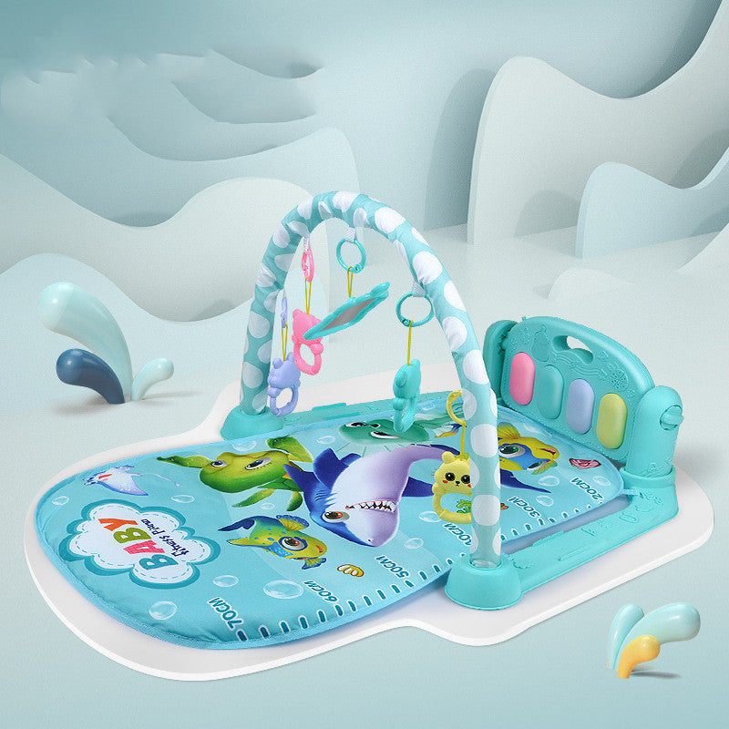 Baby play mat with shark design on a light blue background.