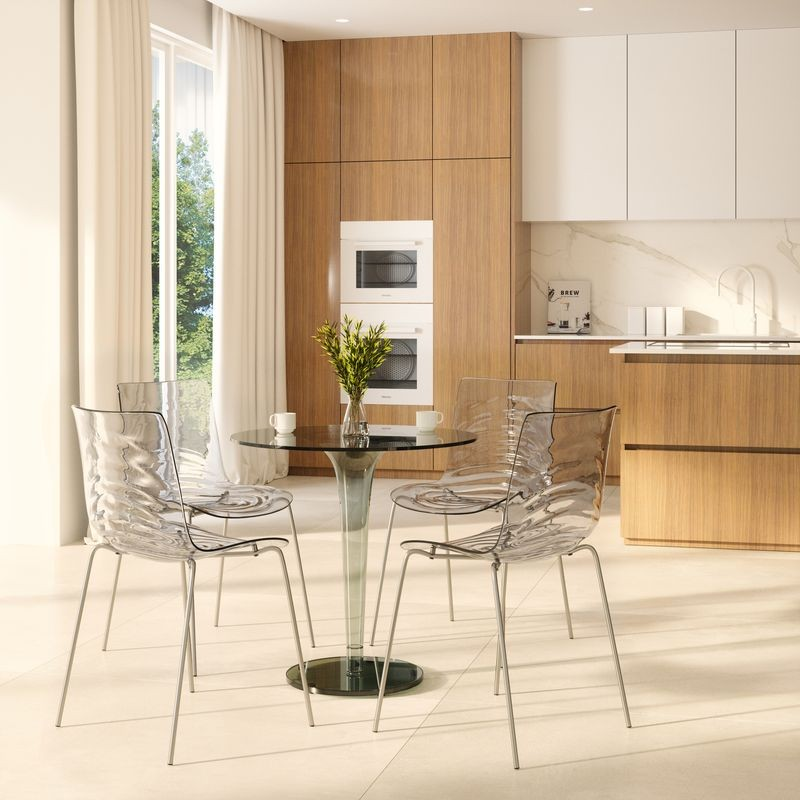 LeisureMod Astor Water Ripple Design Dining Chair Clear at Table.