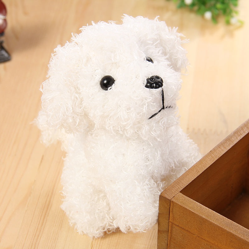 White plush toy dog on a wooden surface.