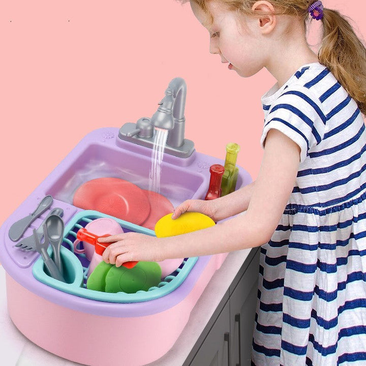 Child playing with a toy kitchen sink set against a pink background.