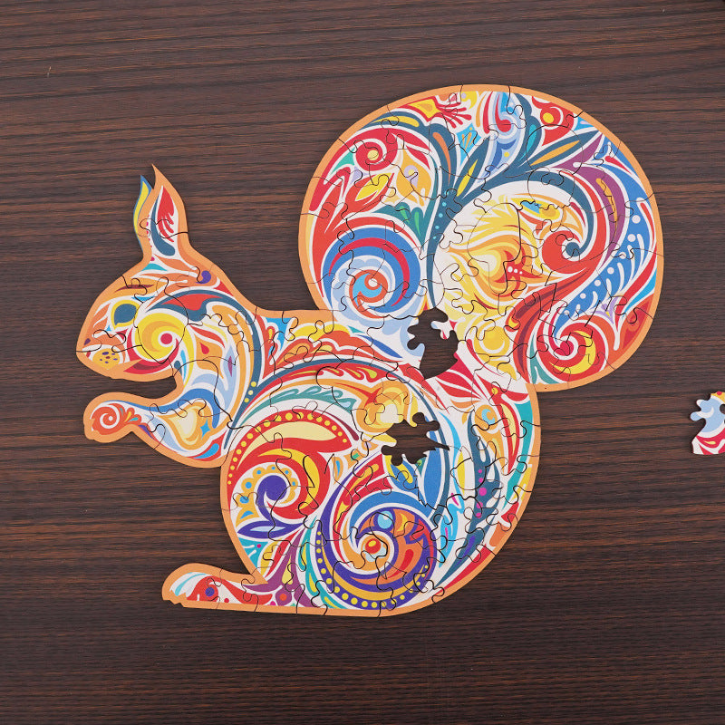 Colorful squirrel-shaped jigsaw puzzle on a wooden surface.