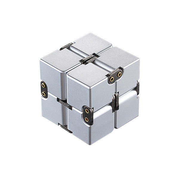 Silver fidget cube with gold accents on a white background.