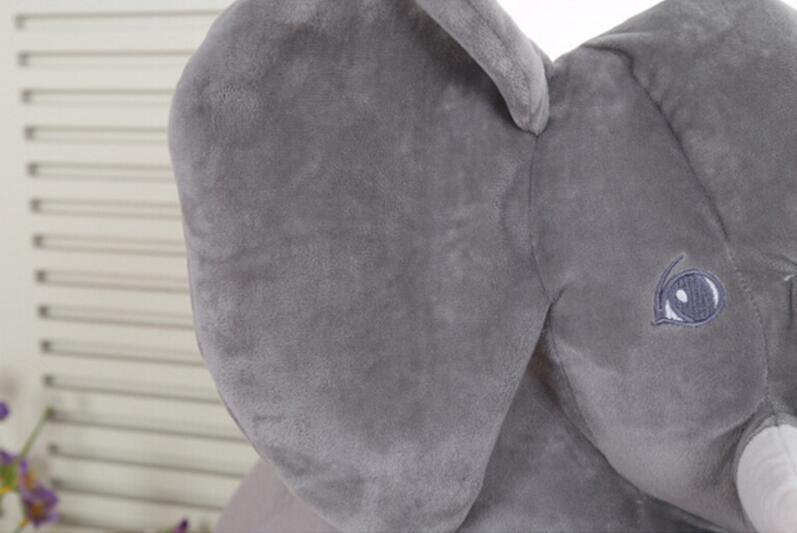 Gray plush elephant toy with a white background.