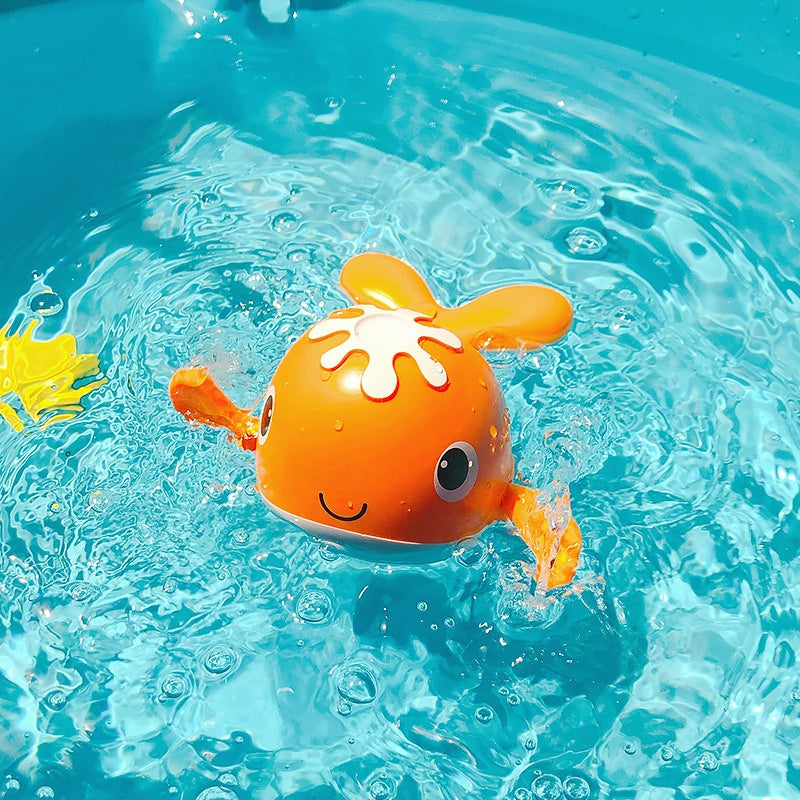 Orange toy octopus floating in clear blue water.