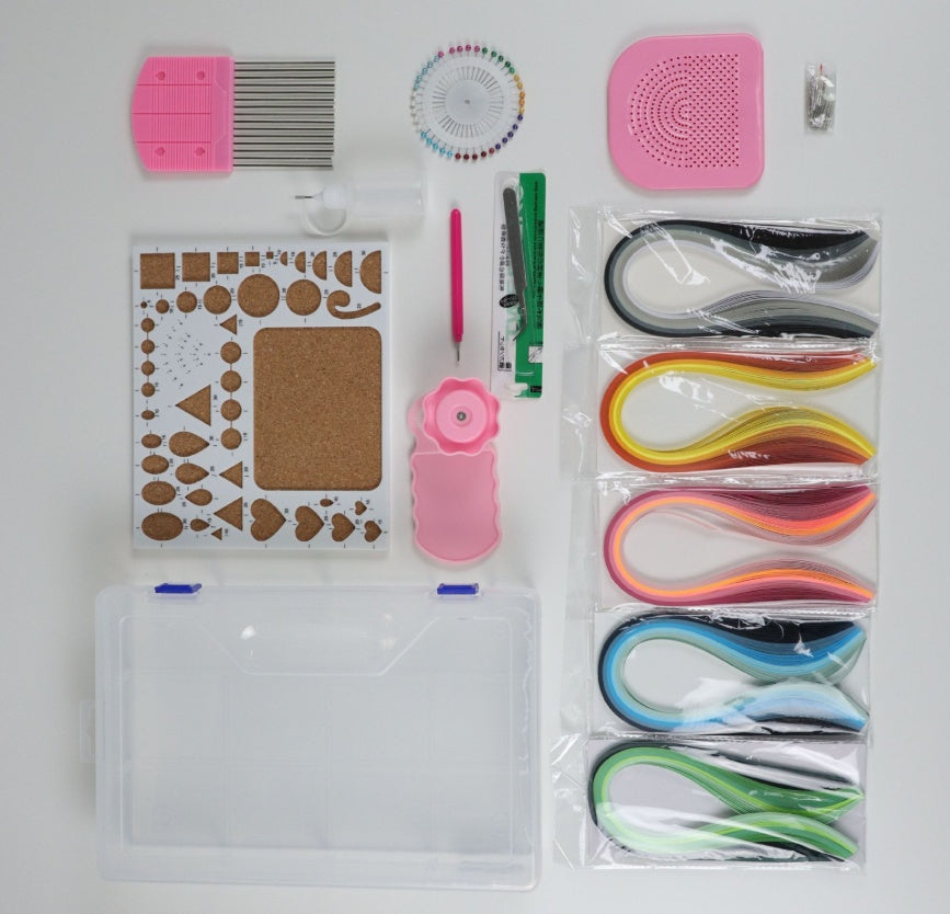 Collection of crafting tools including a stencil, ribbons, and other accessories on a white background.