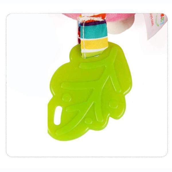 Green leaf-shaped object held by a colorful striped fabric.