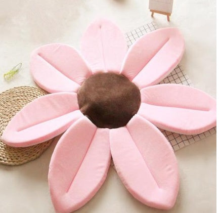 Pink flower shaped mat on a light surface.
