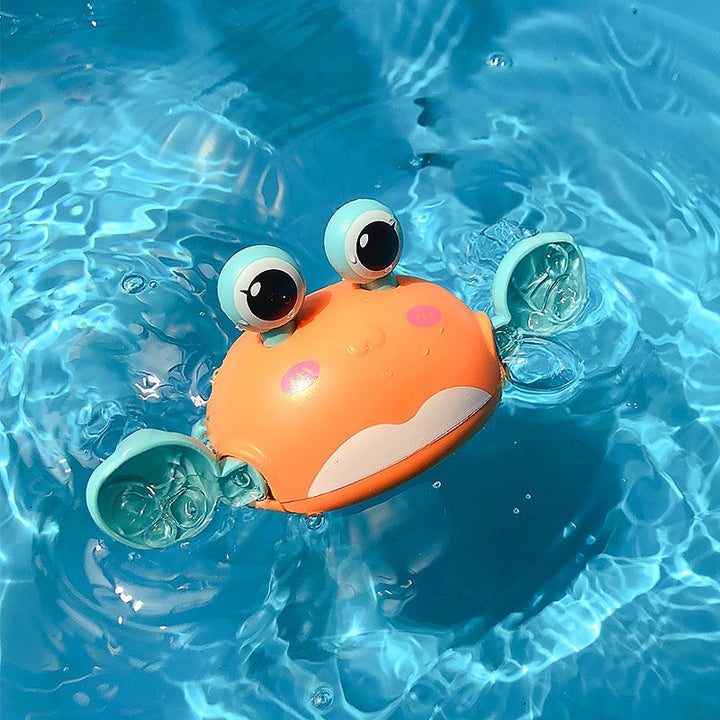Toy crab floating in clear blue water.