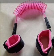 Pink and black leash with a clip on a pink background.