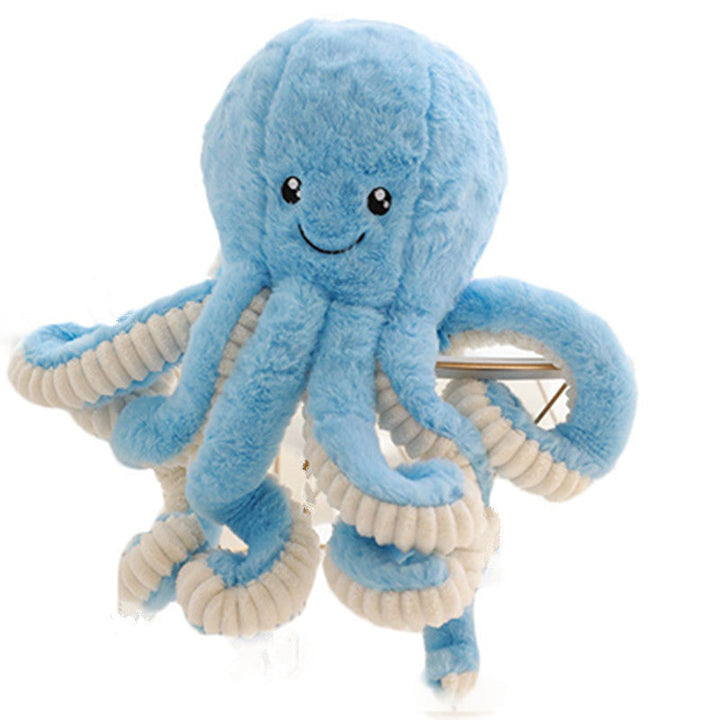 Blue plush octopus toy with a smiling face on a white background.
