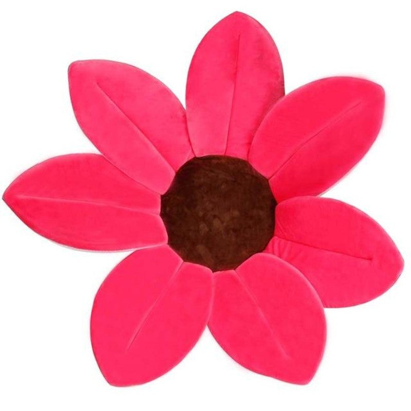 Flower shaped pillow with pink petals and a brown center on a white background.