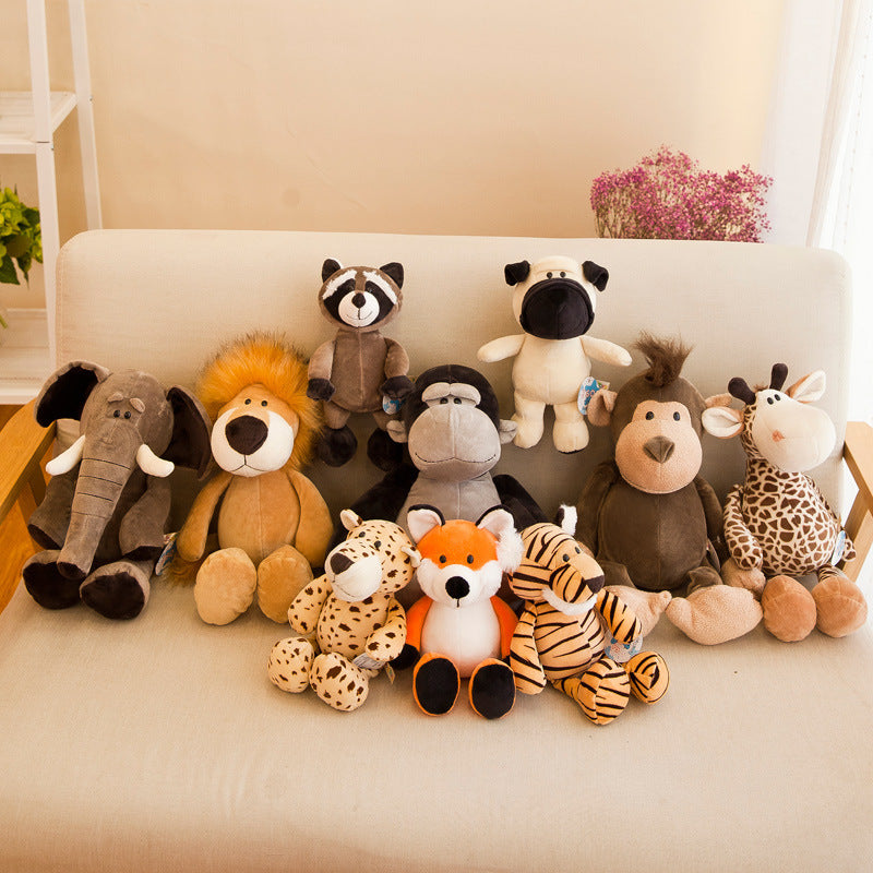 Collection of stuffed animal toys on a white couch with a neutral background.