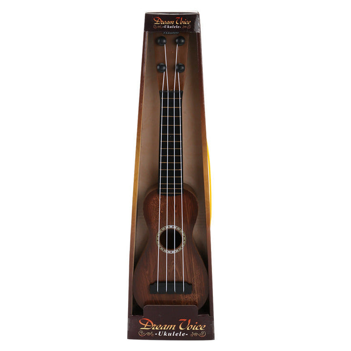 Wooden ukulele in packaging with dream voice branding on a white background.