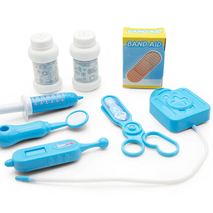 Assorted children's medical toys including a Band-Aid box, syringes, and scissors on a white background.