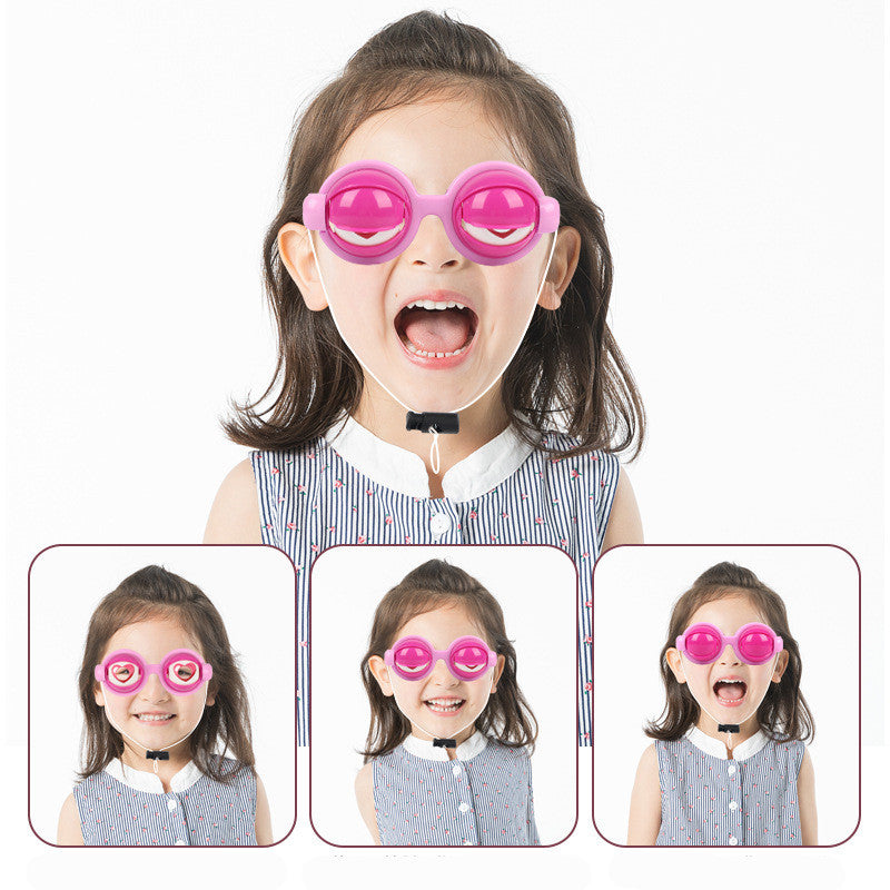 Child wearing pink goggles with a white background.