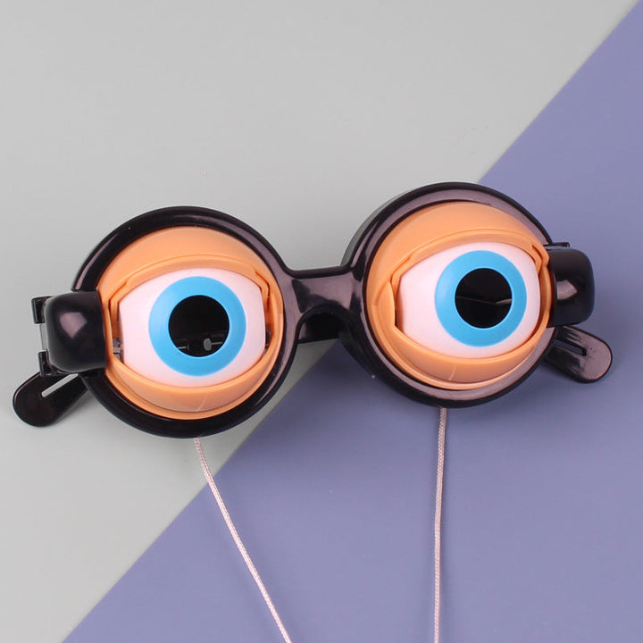 Glasses with large, round, orange lenses on a two-tone gray and purple background.