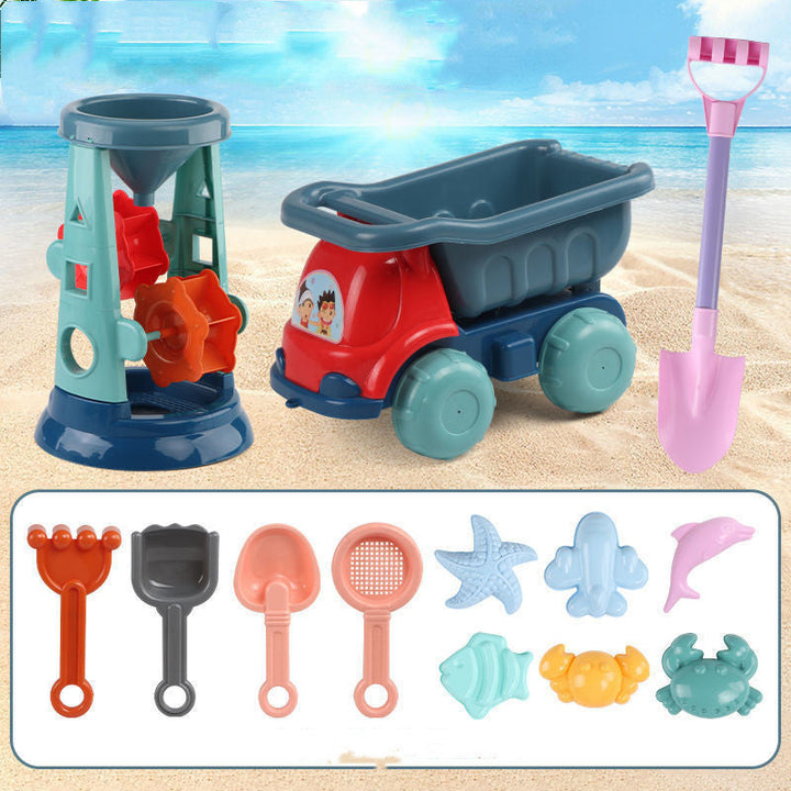 Beach toy set with sandcastle maker, dump truck, and various tools on a sandy background.