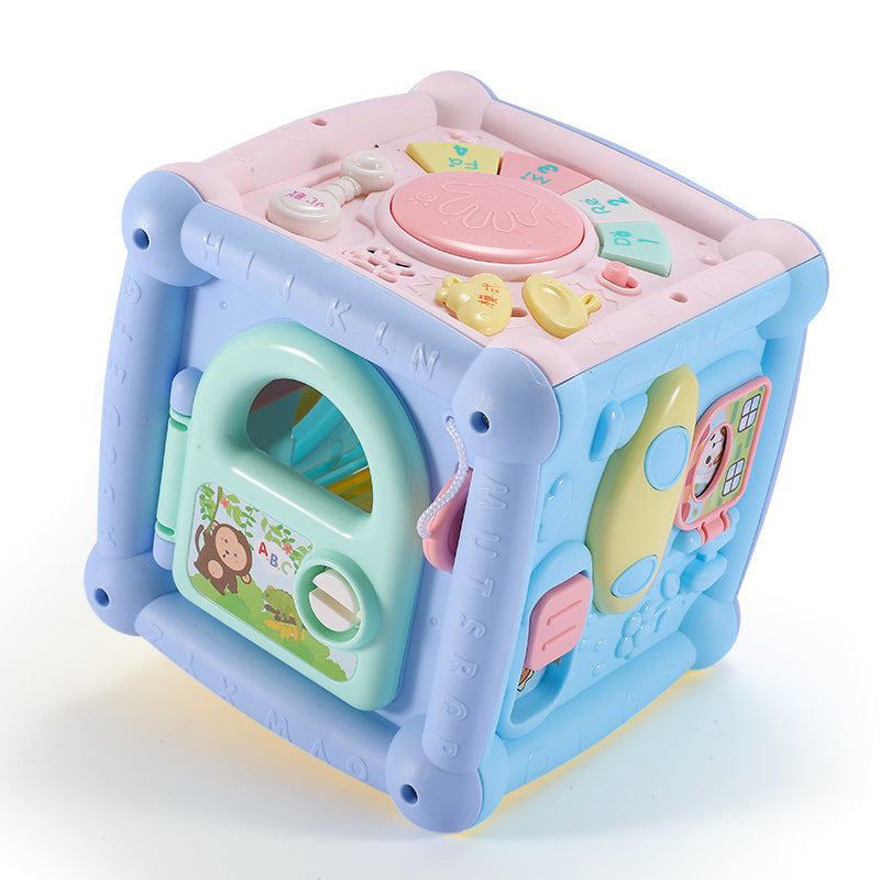 Colorful baby toy cube with various educational elements on a white background.