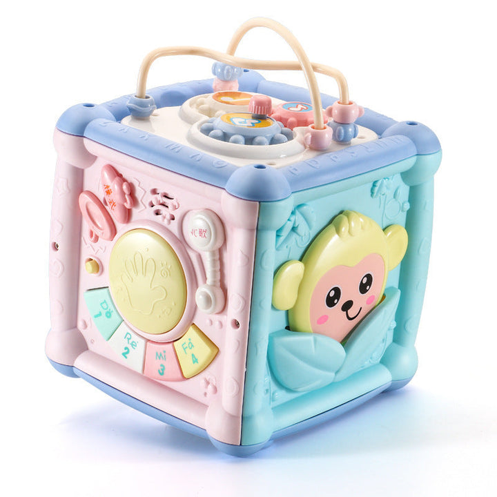 Colorful baby toy cube with cartoon character on a white background.