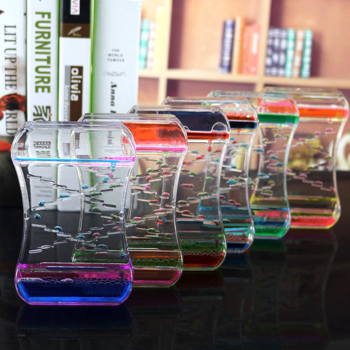 Colorful on a reflective surface with blurred books in the background.