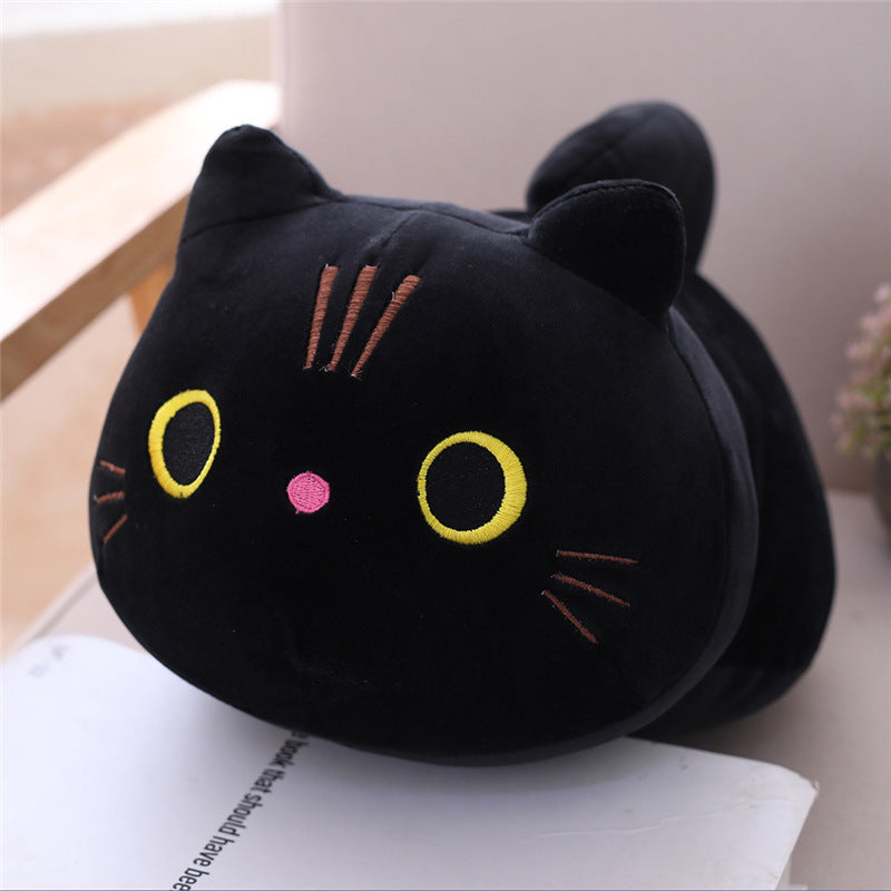 Black cat-shaped plush toy on a surface with a light background.