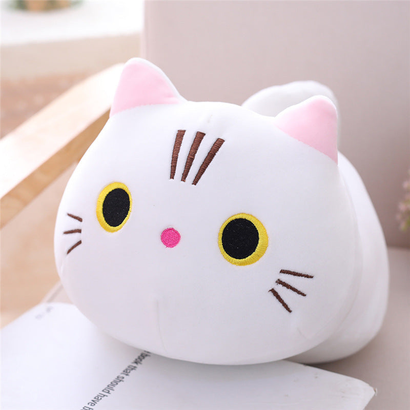Plush toy shaped like a cat face with pink ears and black eyes on a light background.