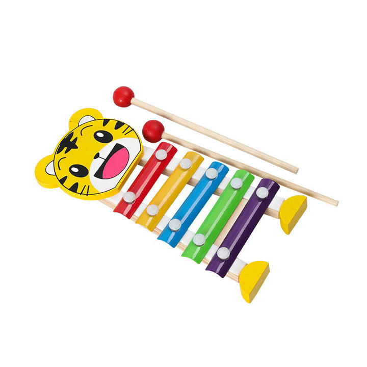 Colorful wooden xylophone with tiger face design on a white background.