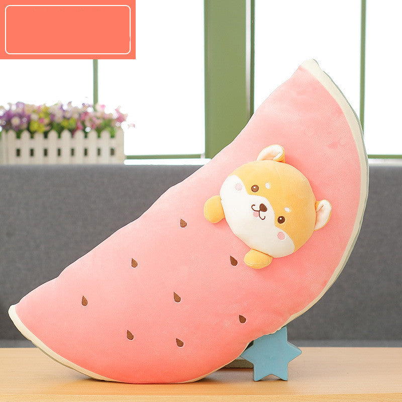 Plush toy shaped like a watermelon with a cute face on a wooden surface.