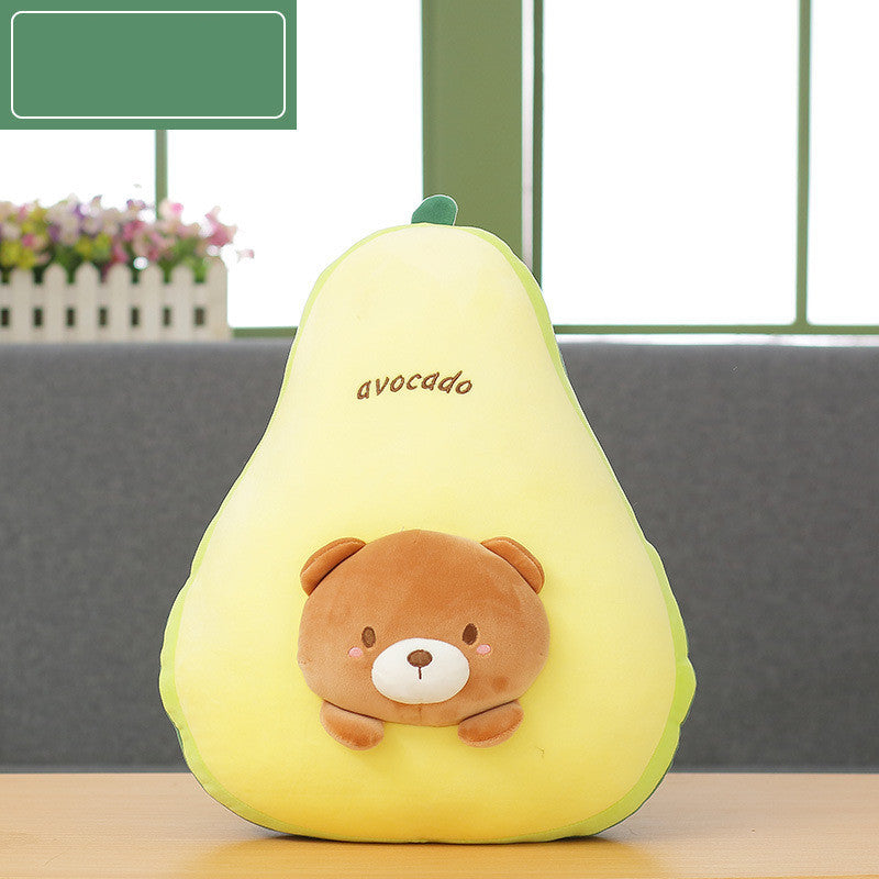 Plush toy shaped like an avocado with a bear design on a table.