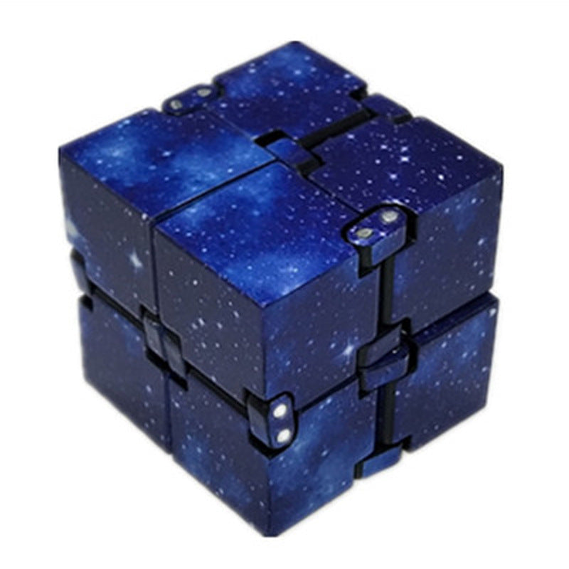 Blue fidget cube with starry design on a white background.