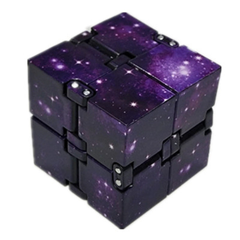 Fidget cube with purple galaxy design on a white background.