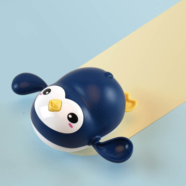 Penguin-shaped bell on a light blue background.