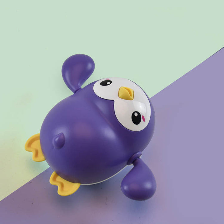 Purple toy penguin on a colorful background.